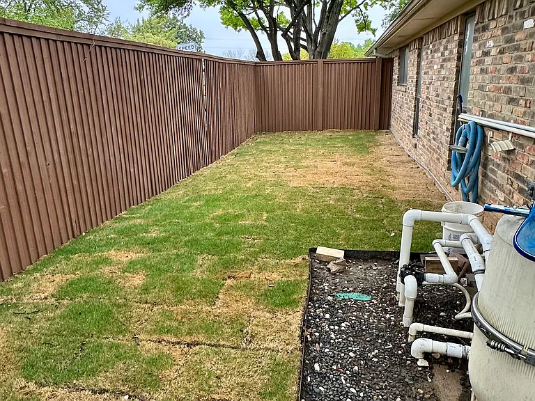 View of grassy yard space featuring a fenced backyard