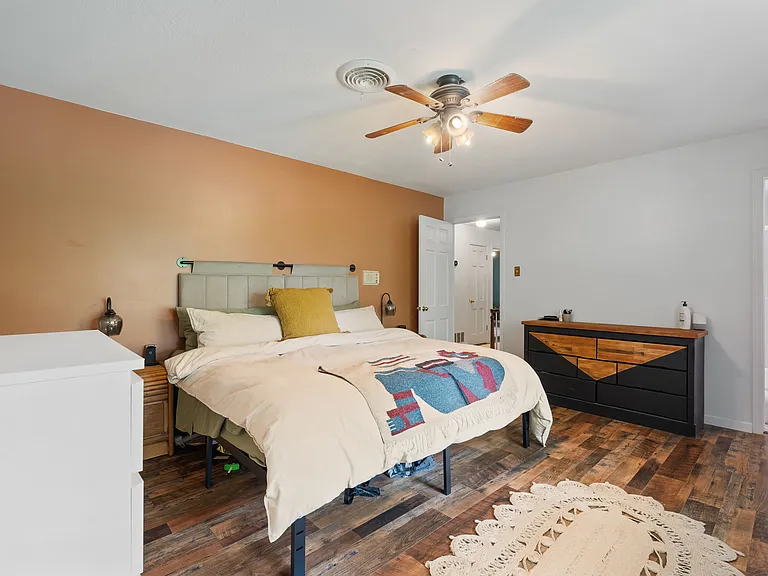 Primary bedroom at the top of the stairs, includes an ensuite bathroom