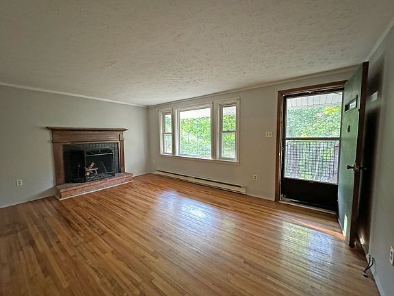 Living Room with Lots of Natural Light. Wood Burning Fireplace with Beautiful Mantle.
