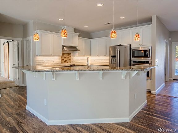 The kitchen is fabulous, with stainless appliances, solid granite countertops and an island with eating bar.