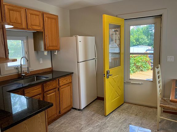 Lots of cabinet storage and sink with contemporary faucet. Stroll out to large back deck with plenty of room for outside enjoyment.