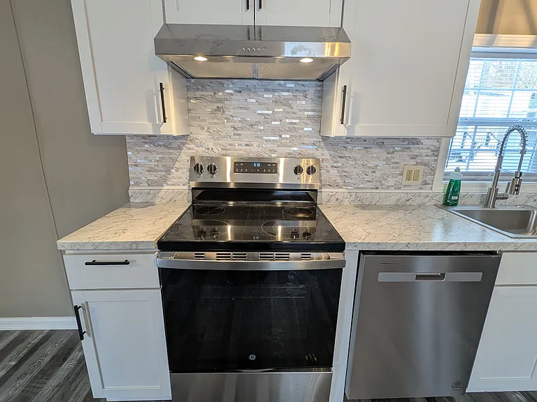 Electric stove with exhaust vent to outside.