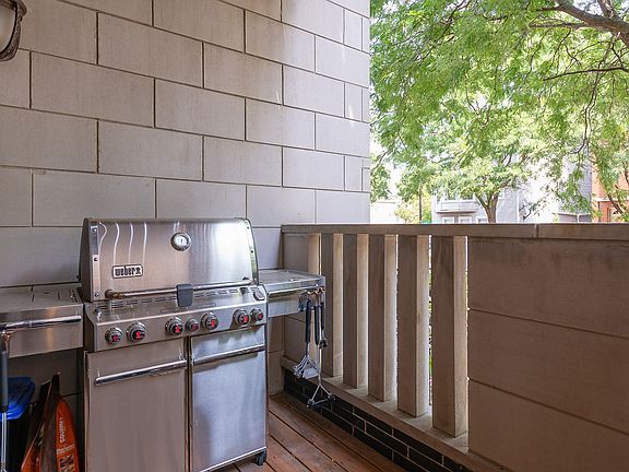 Front balcony is right off of kitchen/dining area and accommodates large grill.