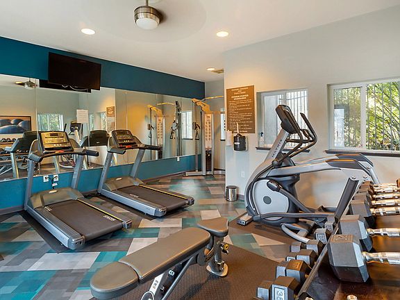 Fitness center with cardio and strength training equipment.