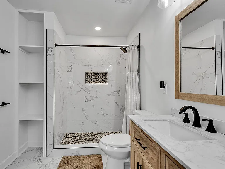 The walk in shower with shelving: Designer tile, built in shelving, and space to truly breathe.