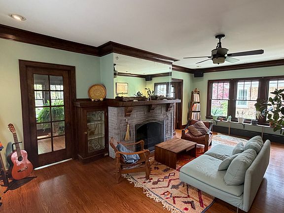 Living room with wood-burning fireplace and lots of light