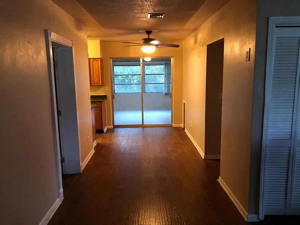 View from front door. Living room immediate right. Bedroom 1 doorway to left. Bedroom 2 and bathroom down hall to right. Kitchen and laundry room back left. Florida room straight ahead.