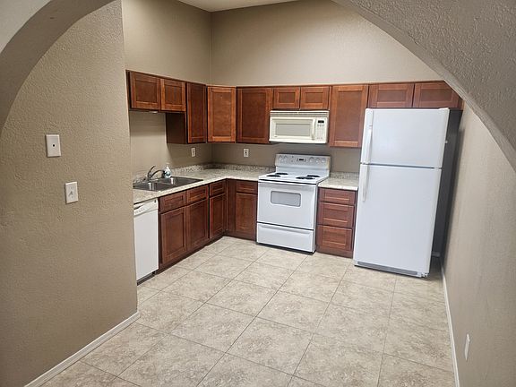 Looking into kitchen from arch entryway.