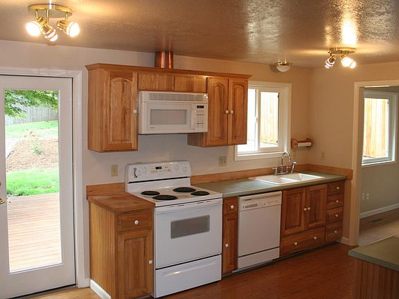 View of kitchen area showing back door through to deck, and 