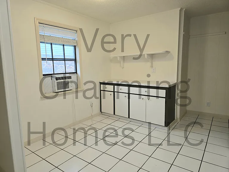 Extra counter and storage space and dining area in the kitchen. The unit does have central air but the window unit remains to cool the kitchen extra while cooking.