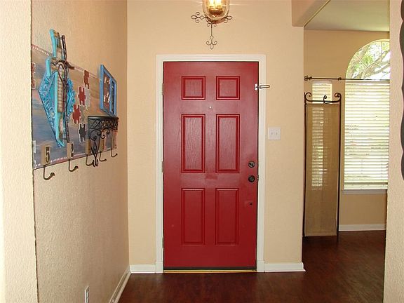 FROM THE INSIDE HERE IS A VIEW OF THE FRONT HALLWAY AND ENTRY INTO THE FRONT ROOM. FLOORING IS VERY ATTRACTIVE.