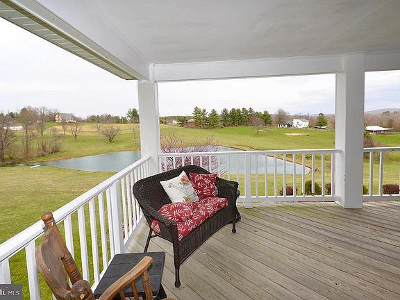 Wrap around porch with scenic views of the pond