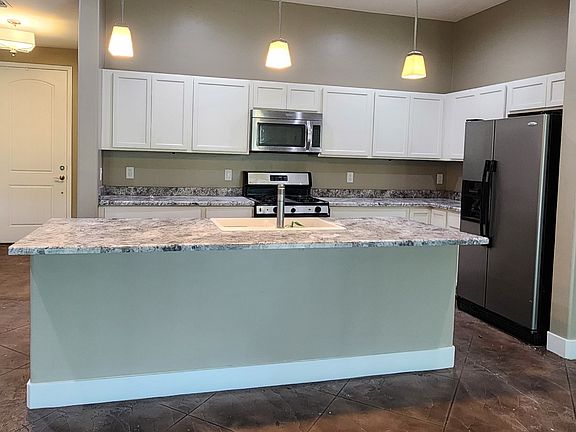 Large open kitchen with large island and overhang. Next to Great Room.