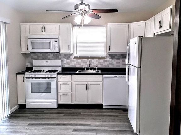 LOOK HOW BRIGHT THIS KITCHEN IS WITH PATIO DOOR AND NEW CABINETS