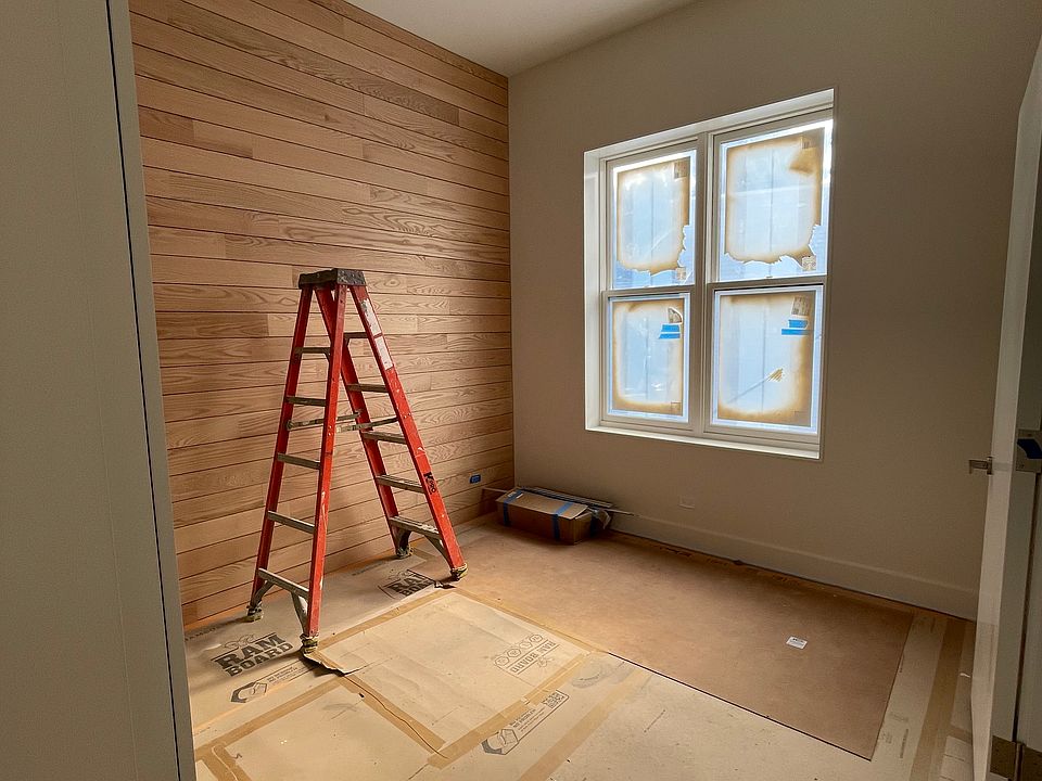 In-progress photo of Bedroom 1. Fits a king-size bed. Has a wooden wall. Has its own bathroom attached.