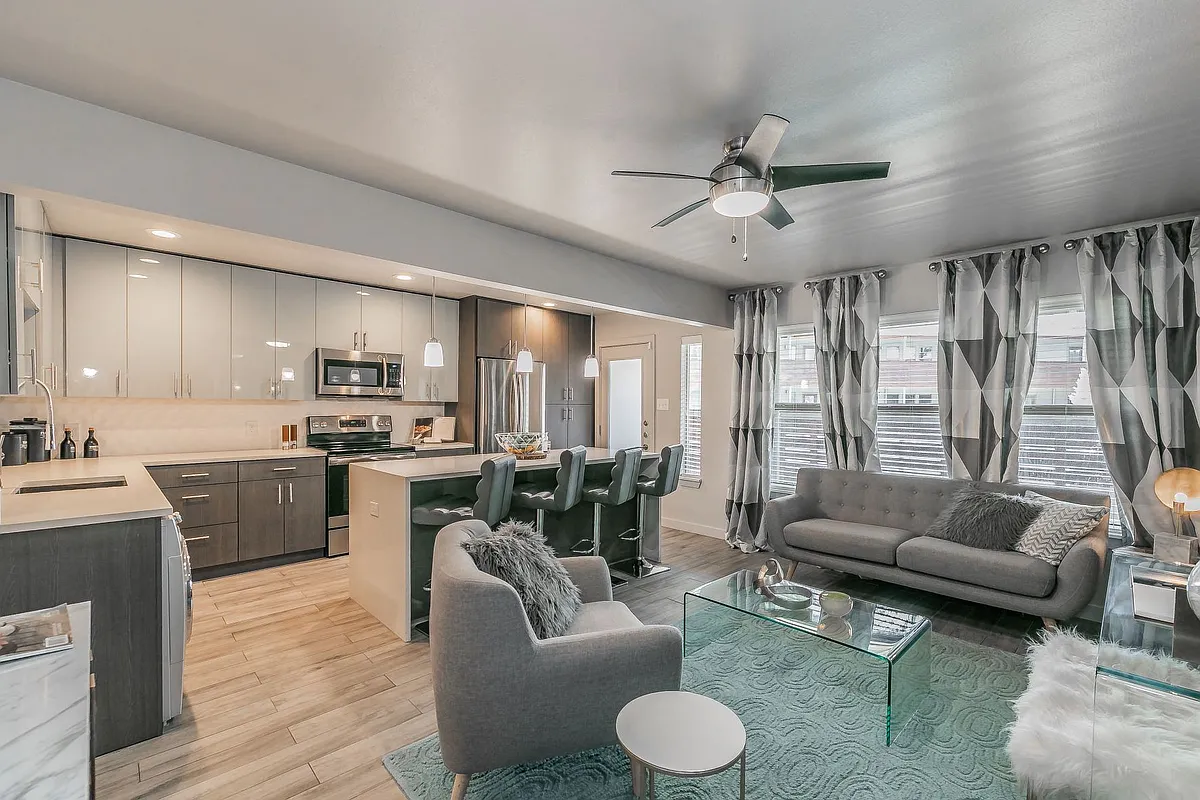 Bright, open-concept living area perfect for relaxing or entertaining. - Reserve on Abrams Apartments
