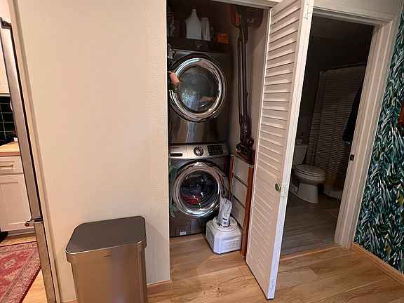 In unit laundry with extra space for laundry supplies.