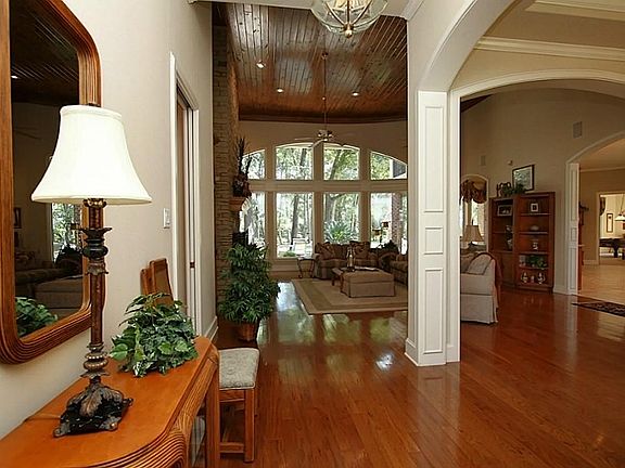  Upon entering you will notice all of the natural light flooding into the home. The great room has a wall of windows with exceptional views of the wooded property and pool. Wood flooring, tongue and groove stained ceiling and recessed lighting.