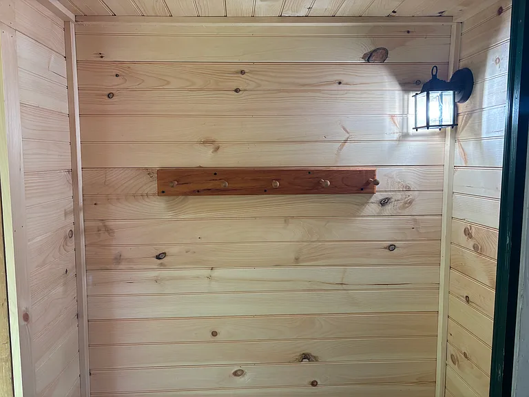 Side entrance new shiplap & coat hooks.