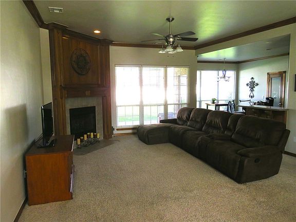 Large living room with fireplace and open to the kitchen/breakfast room.