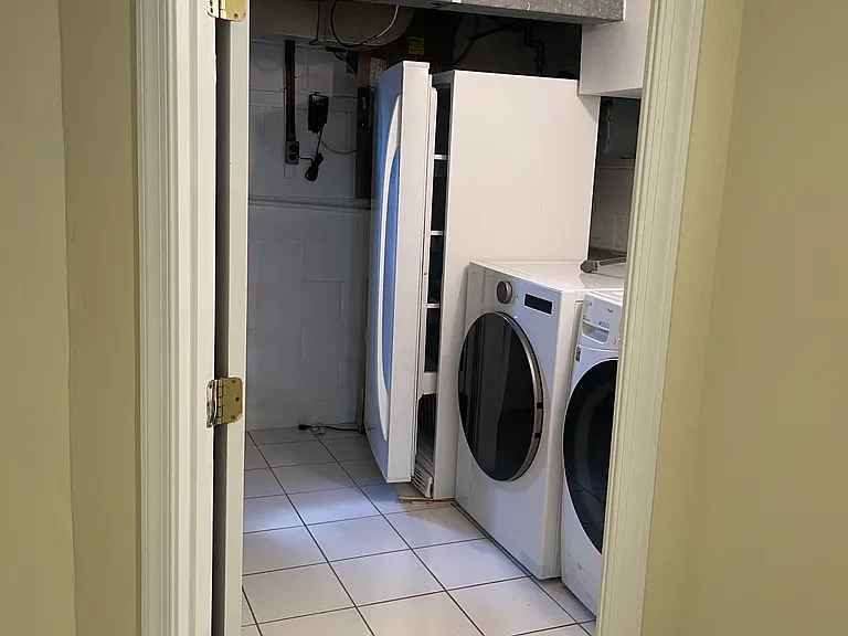 utility room with updated washer and dryer and big freezer