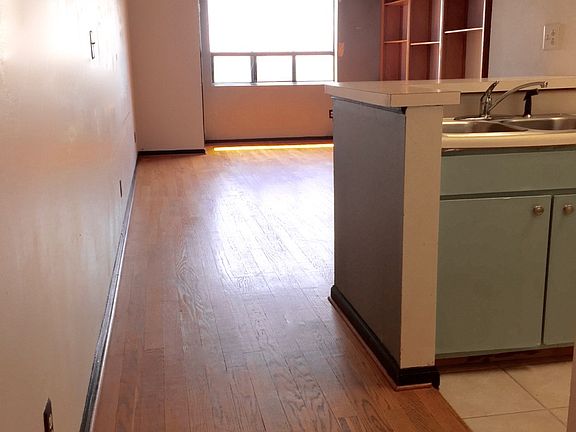 hardwoods, spiral stairs, bright South facing window into UG