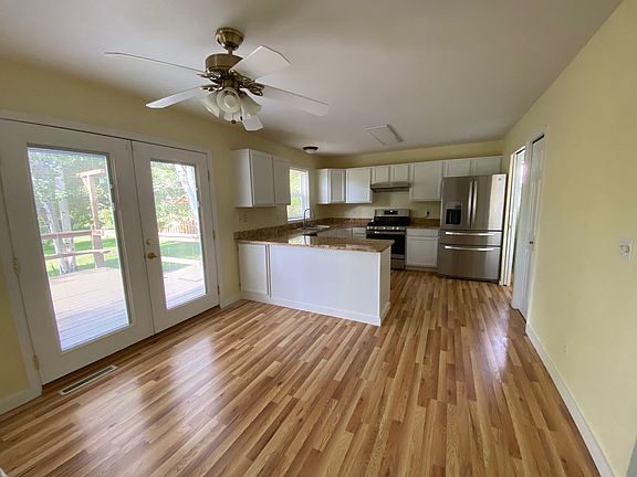 Kitchen with eating area flows off of living room.