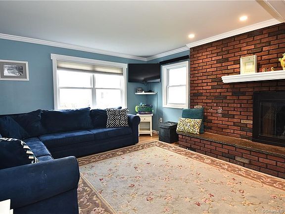 Spacious living room with gorgeous brick fireplace.