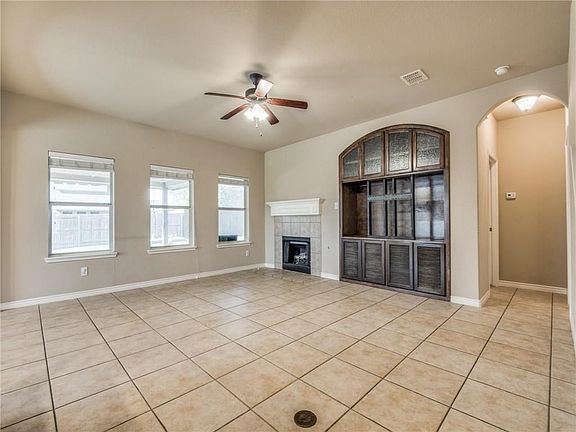 Wall of windows and custom built-ins in downstairs main living area that's open to the kitchen and breakfast room.