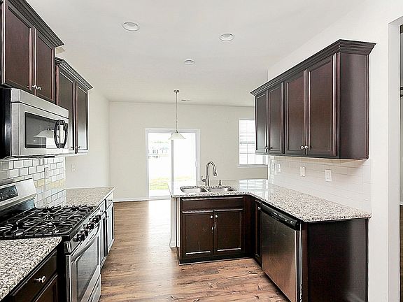 Beautiful dark wood cabinets and granite countertops.