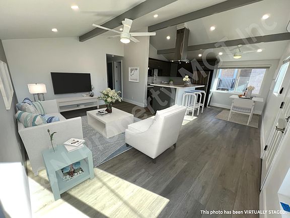 Living room area with dining and kitchen open floor plan