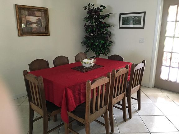 Dining area with french doors leading to patio and pool.