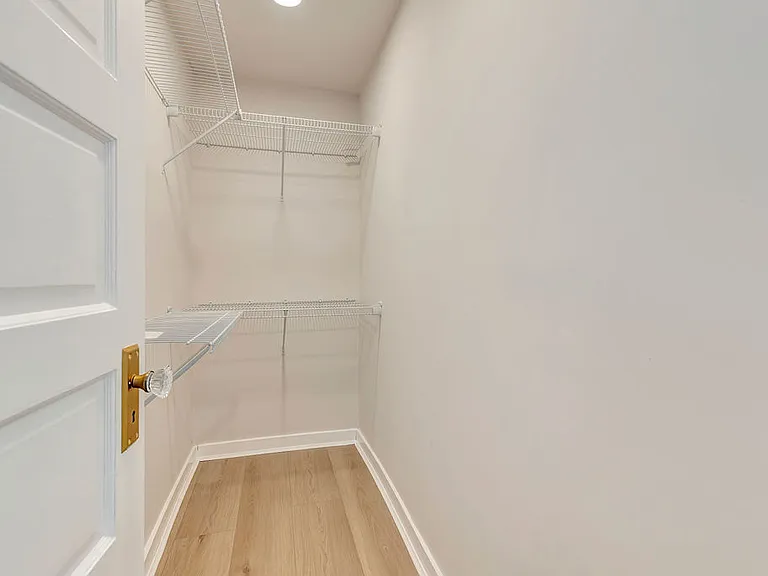 This bedroom has a large walk in closet.