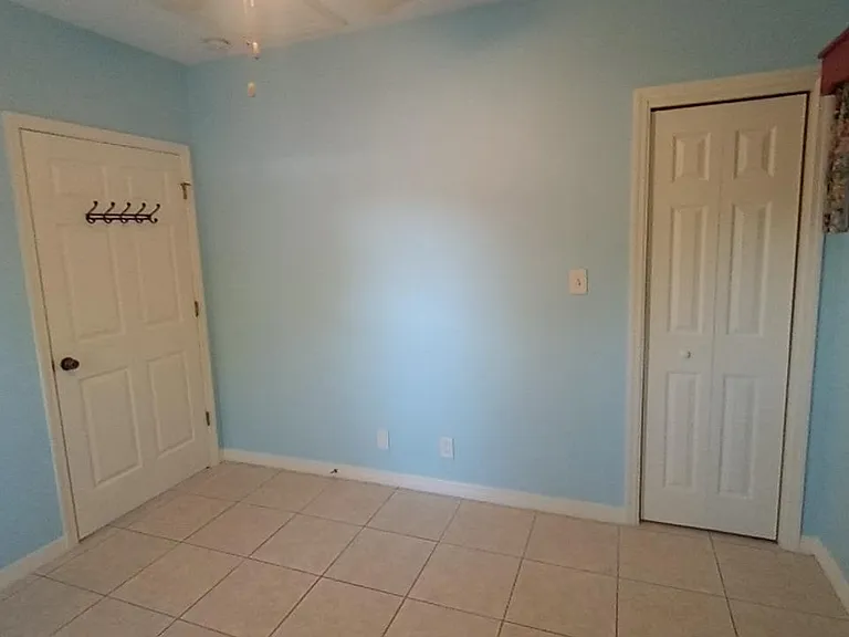East bedroom wall with closed closet.