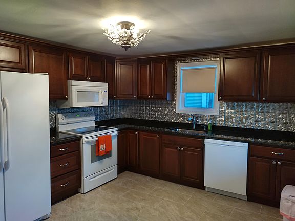 Main kitchen. Included microwave, five burner stove, dishwasher, ice making refrigerator, garbage disposal.