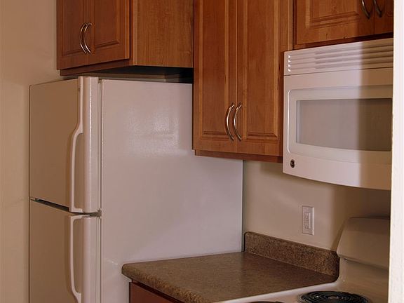 Large refrigerator. Extra tall cabinets. Microwave above ran