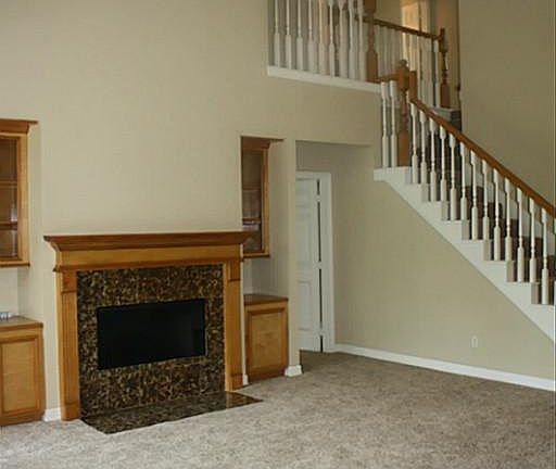 Two story family room with built-ins, updated fireplace and new frieze carpet!
