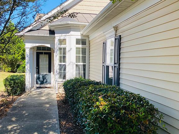 Walkway to the front door. The 2 adjacent windows sit in the kitchen table area.