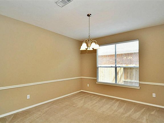 LARGE DINING AREA WITH NEW LIGHTING , CHAIR RAILING, NEW PAINT AND CARPETING