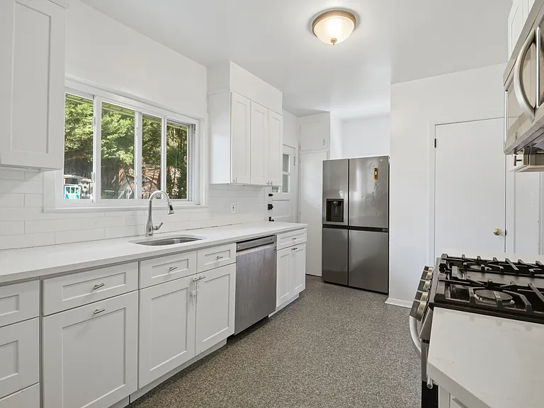 Kitchen equipped with stainless steel appliances and lots of cabinets
