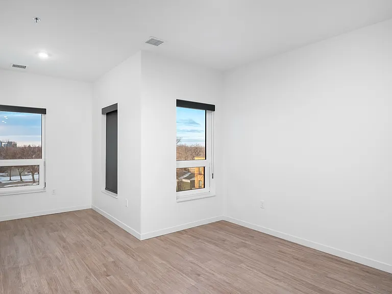 Bright, spacious room with large windows, sleek hardwood flooring, and a serene view, perfect for a modern living space. Bright, spacious room with large windows, sleek hardwood flooring, and a serene view, perfect for a modern living space.