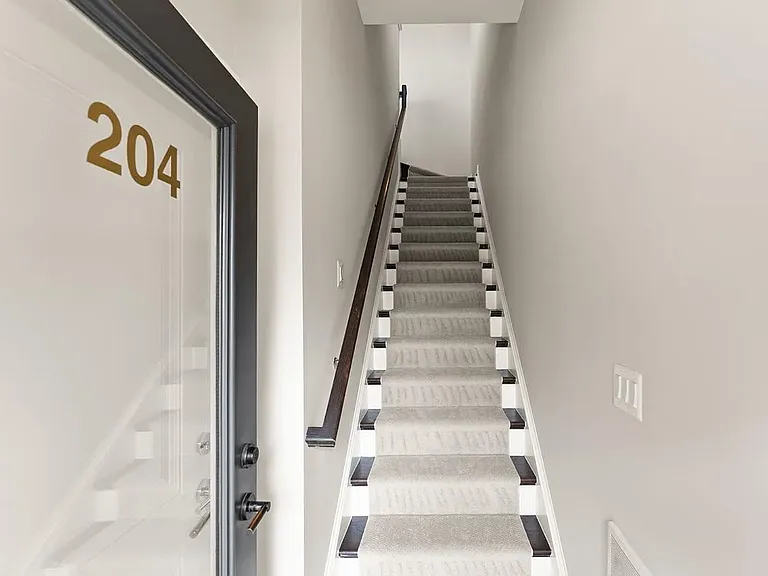First floor staircase leads to inviting second floor living space