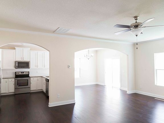 Living room connects to dining area and kitchen