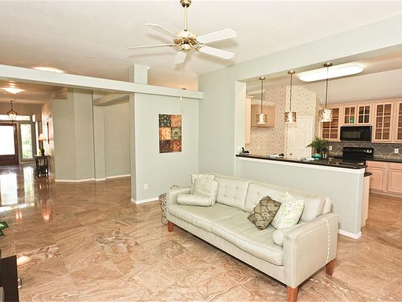 Beautiful Travertine Stone Floors throughout Main Areas. Front Entry Welcomes Guests all the Way int