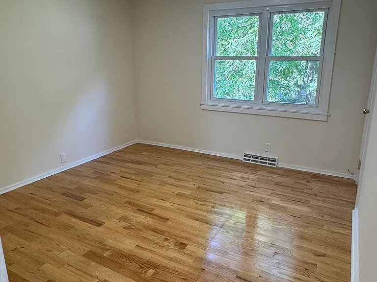 Upstairs front bedroom with wood floors.