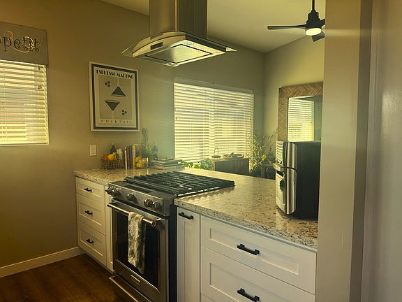 Solid surface countertops and self-closing cabinets. Pull outs for spices and cooking utensils.