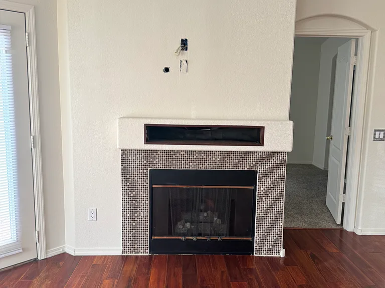 Gas fireplace with A/V cables in wall for a mounted TV.