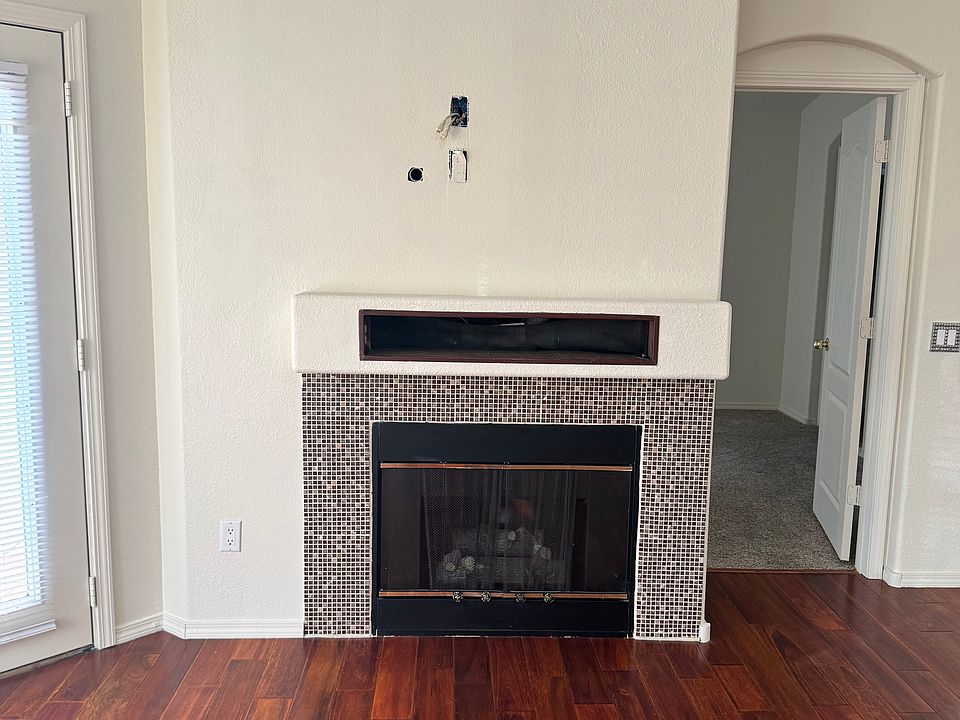 Gas fireplace with A/V cables in wall for a mounted TV.