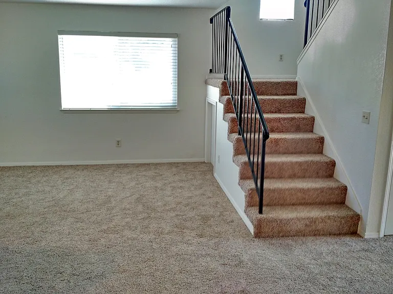 From the dining room upstairs to 2 bedrooms and 1-full bathroom.