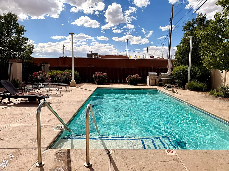 Private gated pool with BBQ grills designed for entertainment, relaxation and lap swimming.